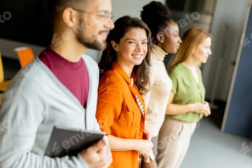 Preview: Young multiethnic startup team standing in the modern office