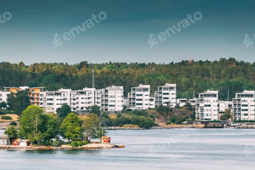 Preview: Sweden. Beautiful Red Swedish Wooden Log Cabin House On Rocky Island Coast In Summer Sunny Evening