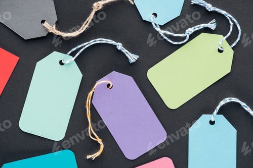 Preview: close up of colorful empty sale tags on black background for black friday
