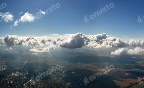 Preview: Aerial view from airplane window at high altitude of earth covered with white puffy cumulus clouds