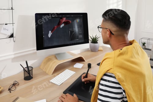 Preview: Professional retoucher working on graphic tablet at desk in office