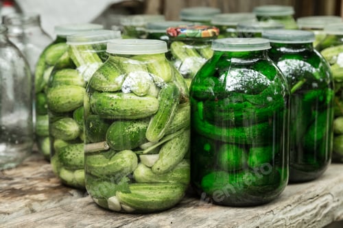 Preview: Large pickles in glass jar.