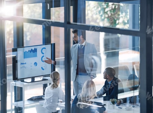 Preview: Shot of a businessman presenting information on a monitor to businesspeople in the boardroom
