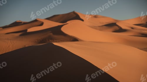 Preview: Warm sunlight illuminating the beautiful curves of the erg chebbi dunes in the sahara desert