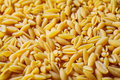 Preview: Italian pasta concept. Uncooked raw Italian gnocchetti sardi pasta background.