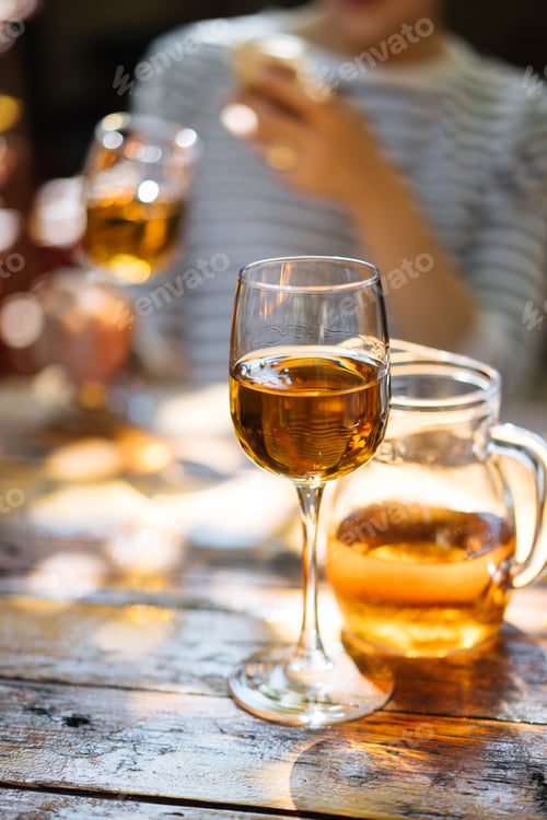 Preview: Woman holding glass of wine
