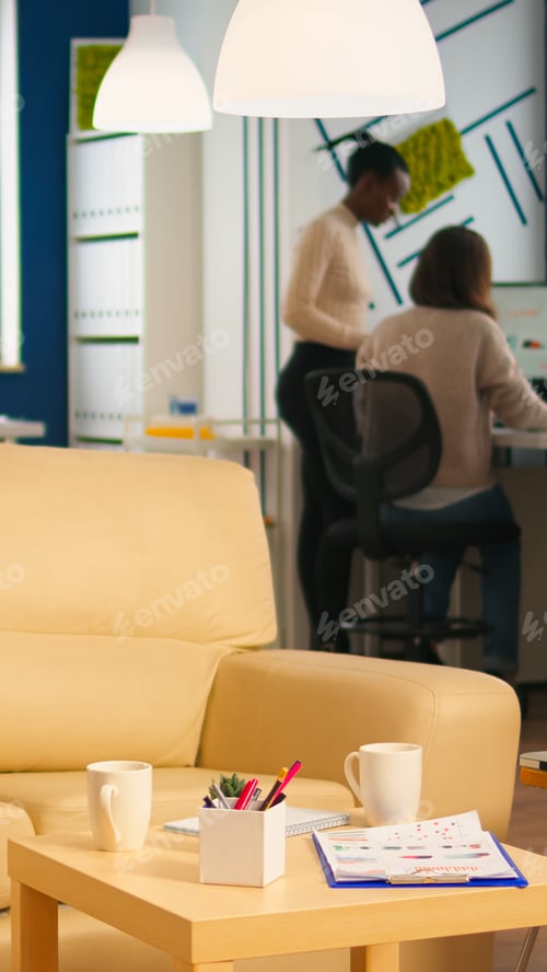 Preview: Diverse business people working in modern start up office