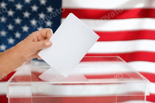 Preview: Elderly woman putting ballot paper into box and American flag on background, closeup