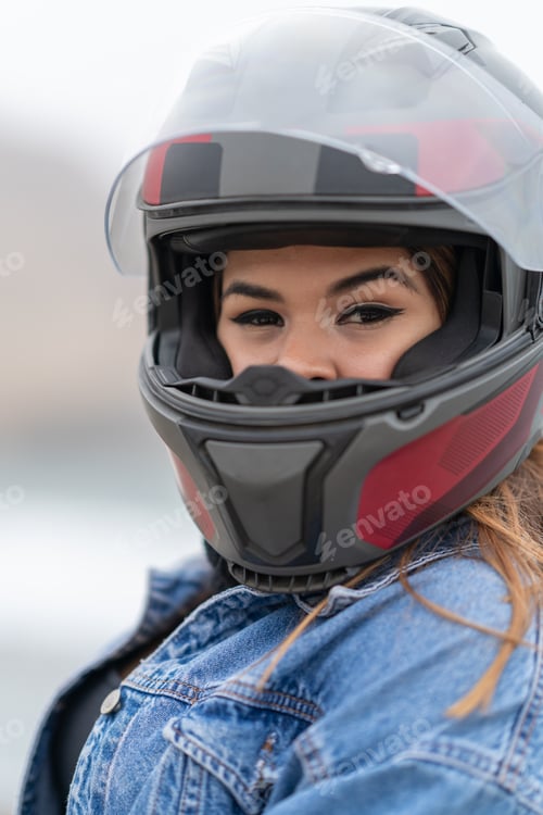 Preview: Portrait of beauty motorbike driver with helmet outdoors