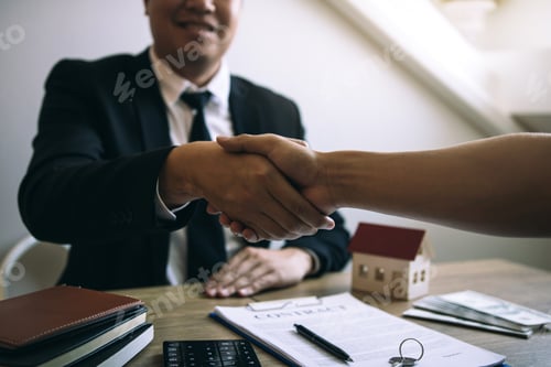Preview: Home sales agents and buyers work on signing new homes and shaking hands.
