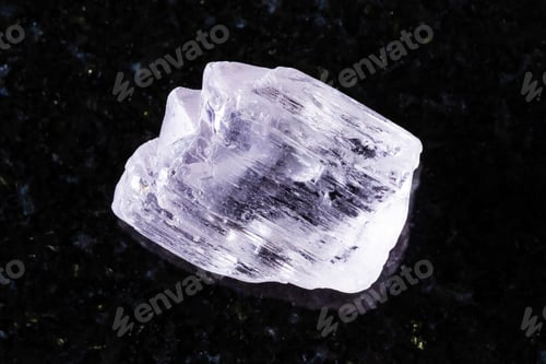 Preview: sample of raw kunzite mineral on black granite