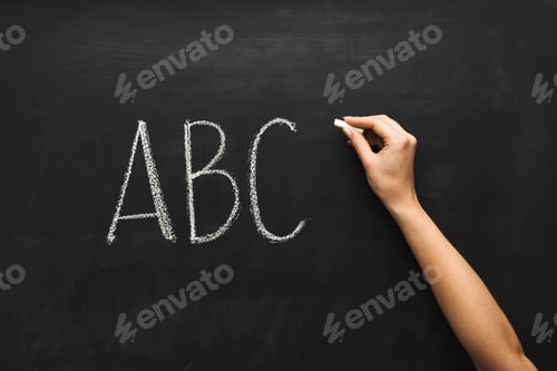 Preview: Woman writing abc on black chalkboard