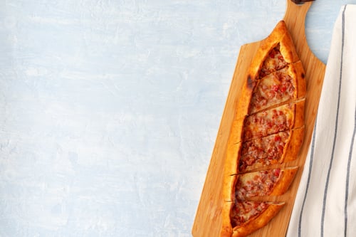 Preview: Turkish baked Pide bread on light blue wooden surface