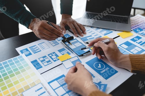 Preview: ux developers, UI designers Asian group data researchers brainstorm on tabletop mobile app interface