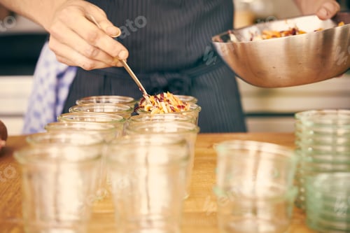 Preview: Chef filling plastic containers with portions of food