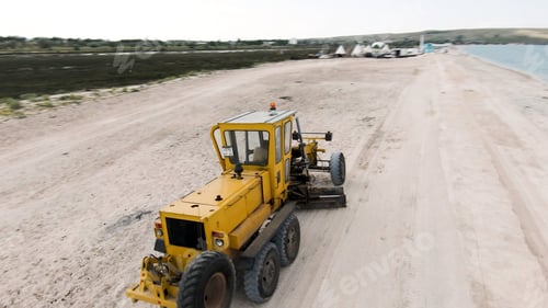 Preview: Yellow transport on the beach. Action. View of thw drone. Wonderful scenery of coast. Huge beach