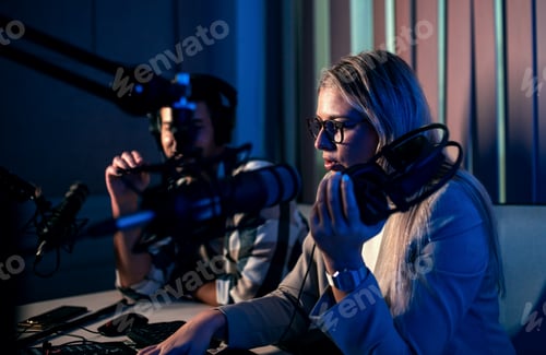 Preview: Young woman and man editing audio podcast in their studio.