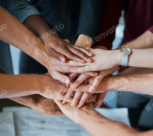 Preview: Shot of a group of unrecognisable businesspeople joining their hands together in unity