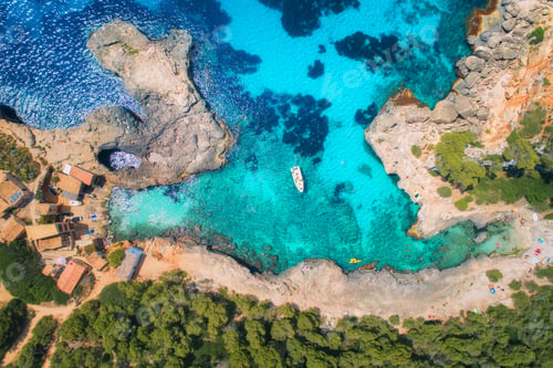 Preview: Aerial view of clear sea with blue water, boat and green trees