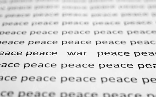 Preview: War and peace concept. Close-up of printed text of words Peace and one word War on white paper.