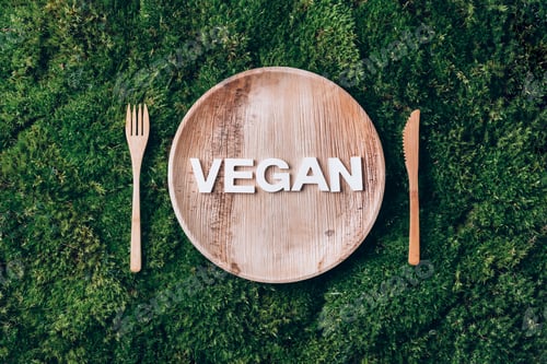 Preview: Wooden disposable tableware from natural materials with word VEGAN, wooden spoon, fork on green moss