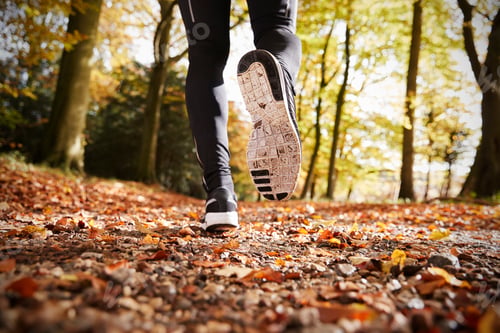 Preview: Close Up Of Male Runners Feet On Run Through Autumn Landscape