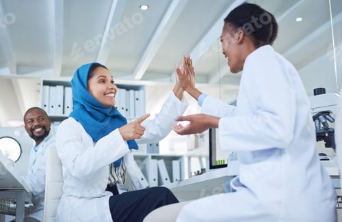 Preview: Shot of two scientists giving each other a high five while conducting research in a laboratory