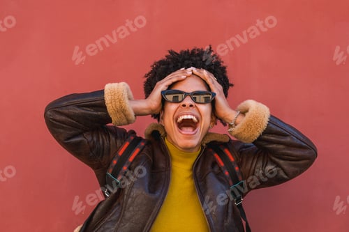 Preview: Excited young woman screaming with hands on head