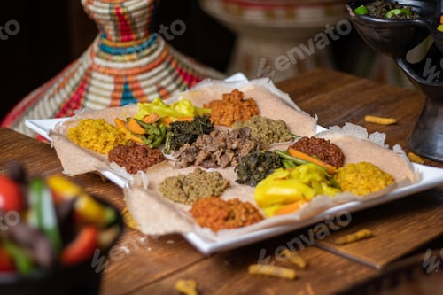 Preview: High angle shot of a plate of traditional Ethiopian food's ingredients on a wooden surface