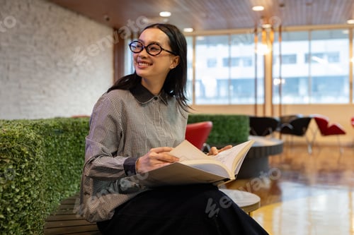 Preview: Woman Reading Quietly in Modern Library