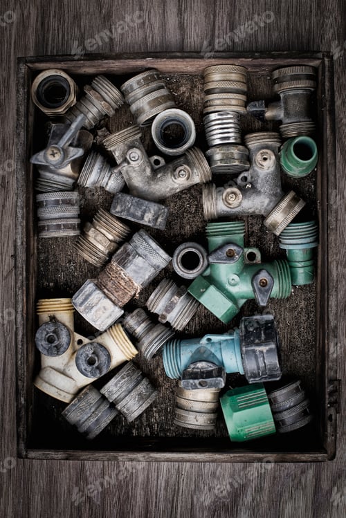 Preview: Washers and hose pipe joint fittings in a wooden box in the greenhouse.