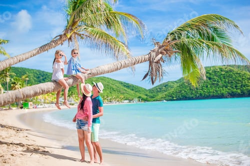 Preview: Little girls having fun sitting on the palm tree