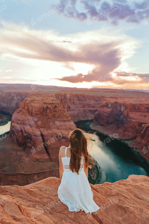 Preview: Happy girl on the edge of the cliff at Horseshoe Band Canyon in Page, Arizona. Adventure and tourism