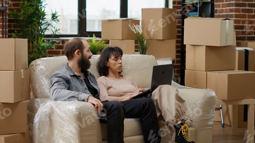 Preview: Husband and wife buying home furniture online on laptop