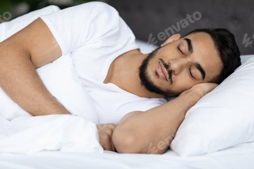 Preview: Portrait Of Young Handsome Middle Eastern Guy Sleeping In Bed At Home