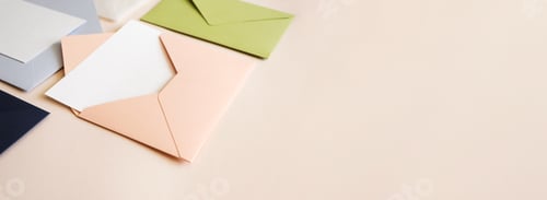 Preview: Close-up colorful mail envelopes on beige background horizontal banner