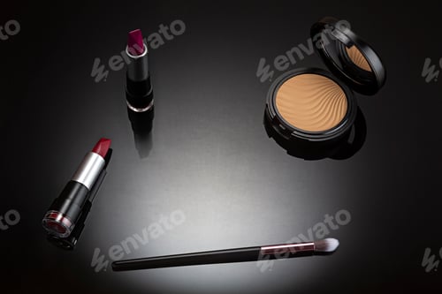 Preview: Cosmetic makeup set seen from above on black background with spot lighting.