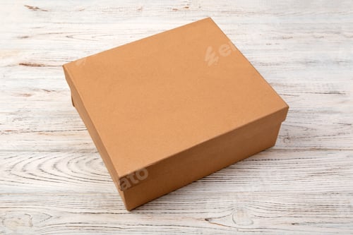 Preview: Brown closed cardboard box on a wooden background. top view, blank for you design