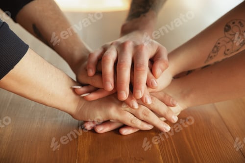 Preview: Close up of caucasian male and female hands, covering one another, team, friendship, business
