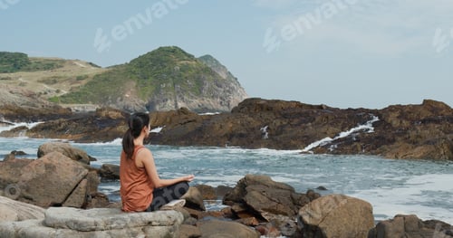 Preview: Woman do yoga beside the sea beach