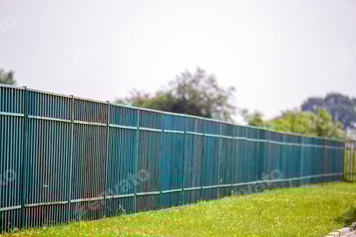 Preview: Long rusty old metalic fence.