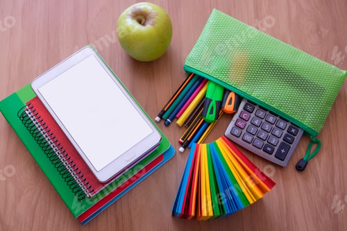 Preview: Back to school. School supplies on wooden desk, books and digital tablet with wide screen