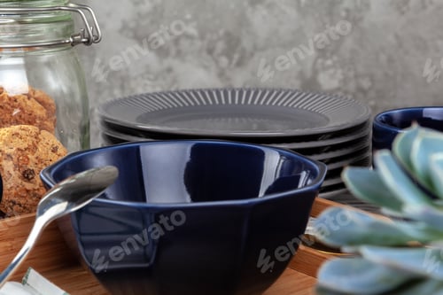 Preview: Wooden kitchen counter with new dishware on it
