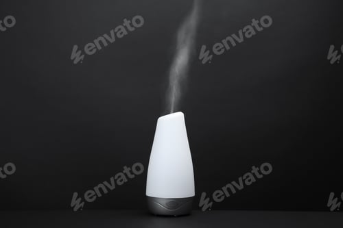 Preview: Modern aroma humidifier on black background. Space for text