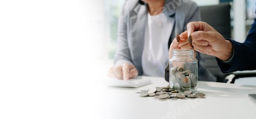 Preview: saving money with hand putting coins in jug glass and calculator to calculate budget concept