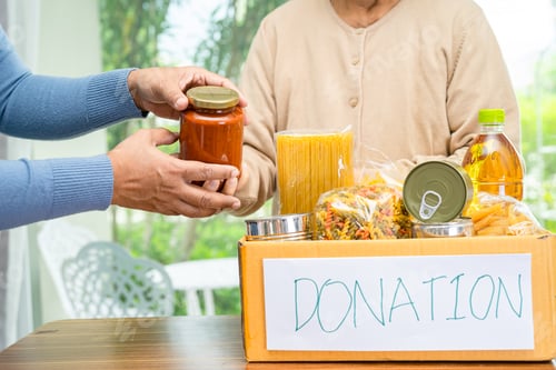 Preview: Volunteers putting various dry food in donation box for help people.