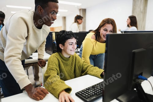 Preview: Young students using computers inside technology class at school room - Focus on center girl face