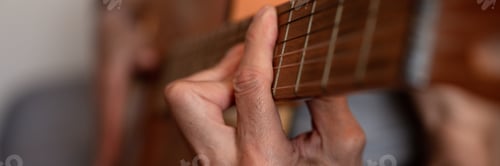 Preview: male hands elderly senior man holding playing classical guitar at home. guitarist play amateur music