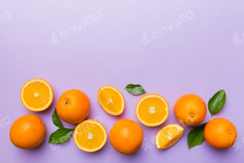 Preview: fresh Fruit orange slices on colored background. Top view. Copy Space. creative summer concept.