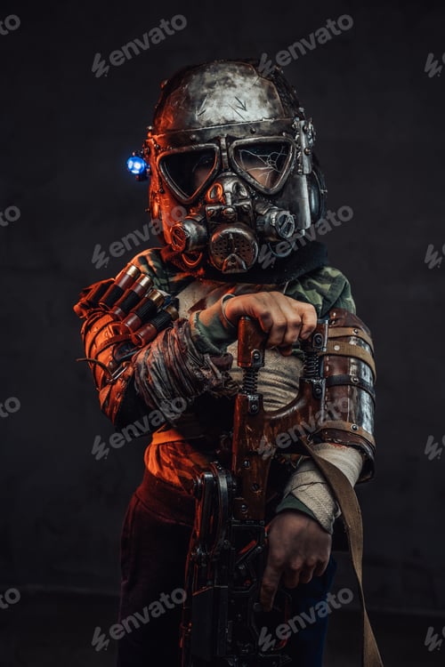 Preview: Armed with riffle little boy with gas mask in dark background